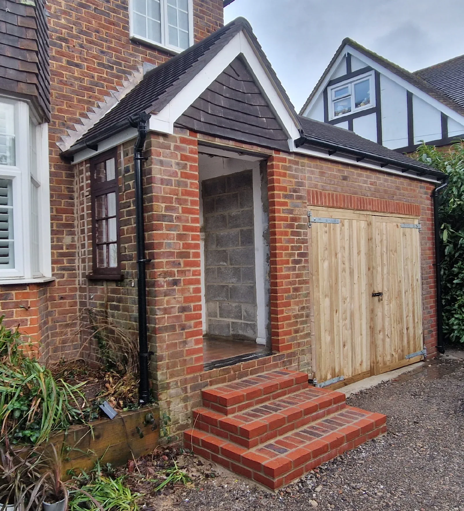Finished brick steps and entrance beside the timber doors