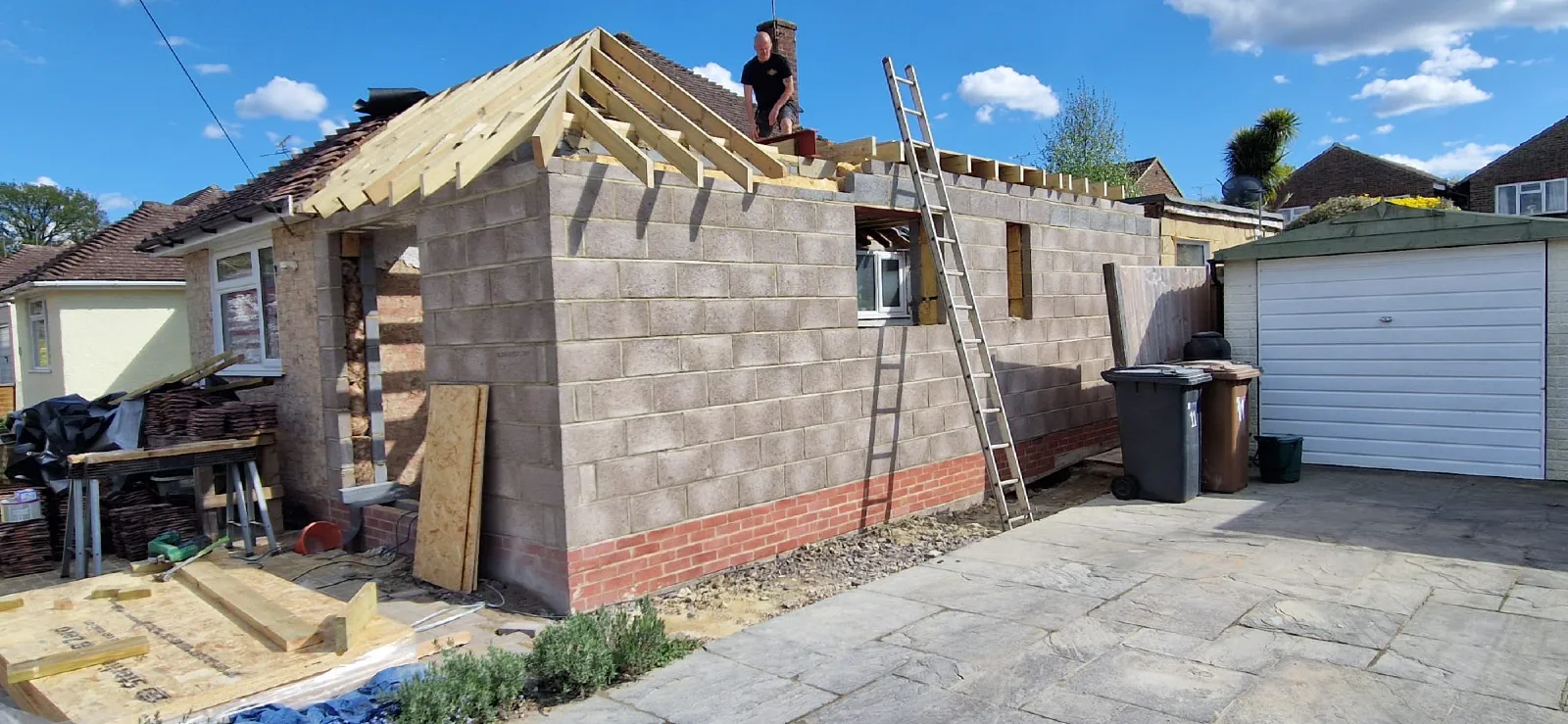 Timber roof structure being built over the extension